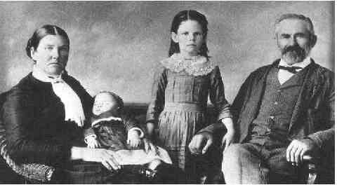 Sophronia Caviness holding Nancy, girl standing is Ellen, and John Gerhardt.